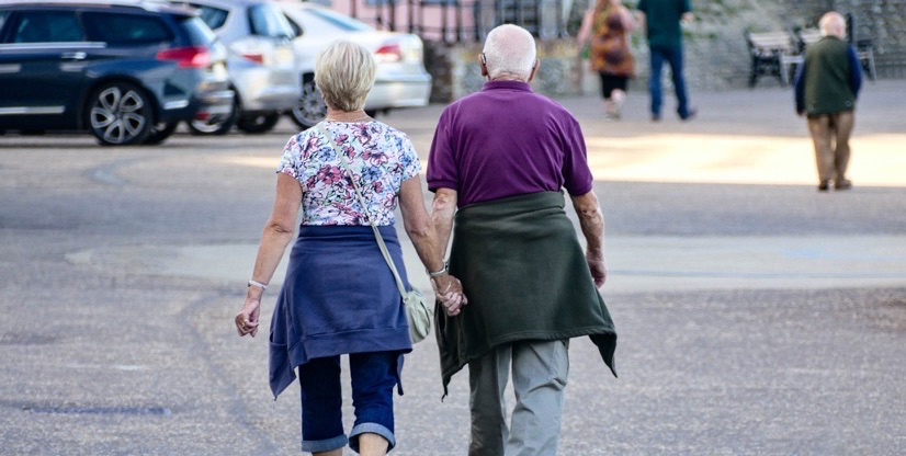 Older couple walking down the street